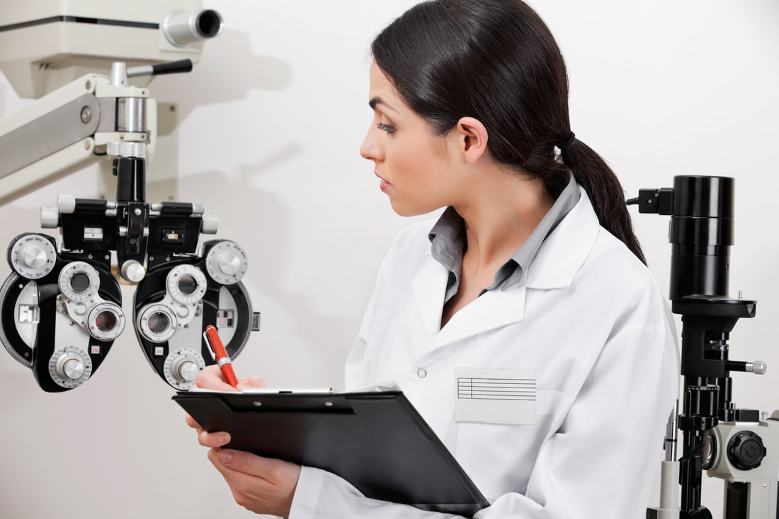 woman checking her eye examination equipment 